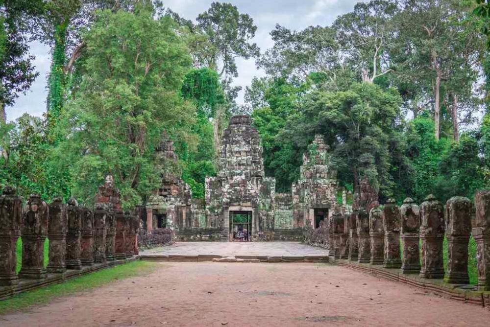 Angkor Grand Circuit Preah Khan temple ruins with tree roots and 12th century Khmer carvings